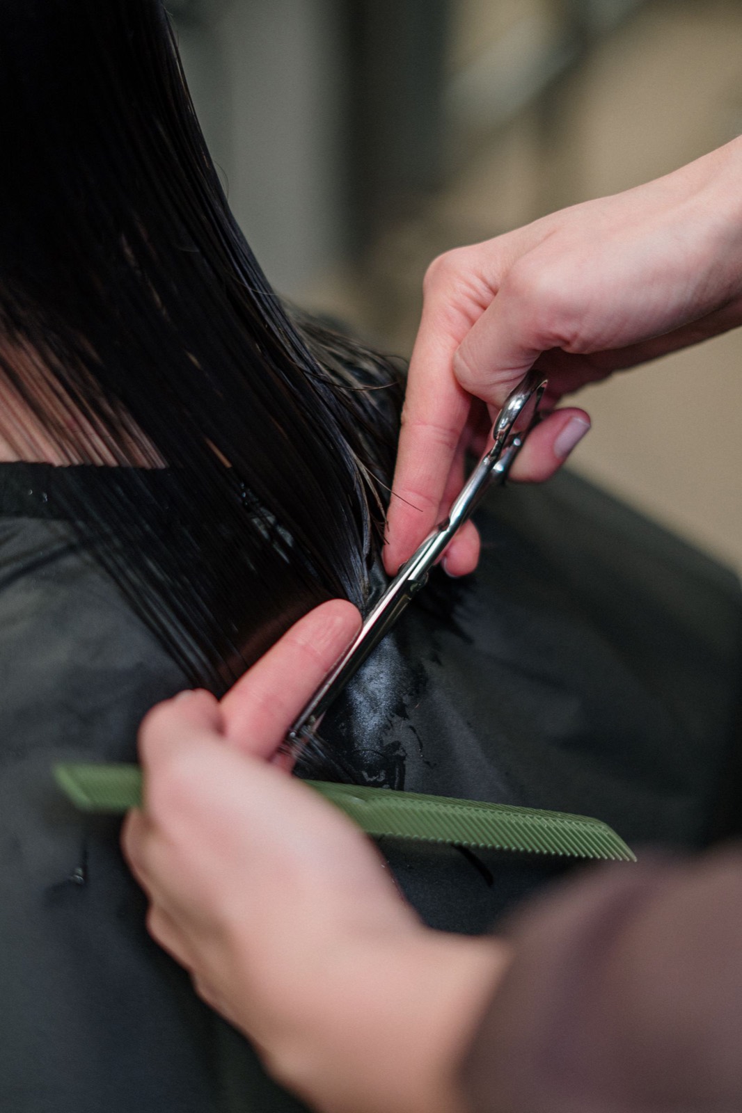 A stylist cutting hair by the window at Fox & Fern